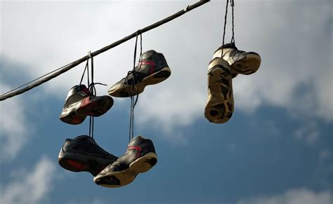 sneakers on power lines|why people throw shoes on power lines.